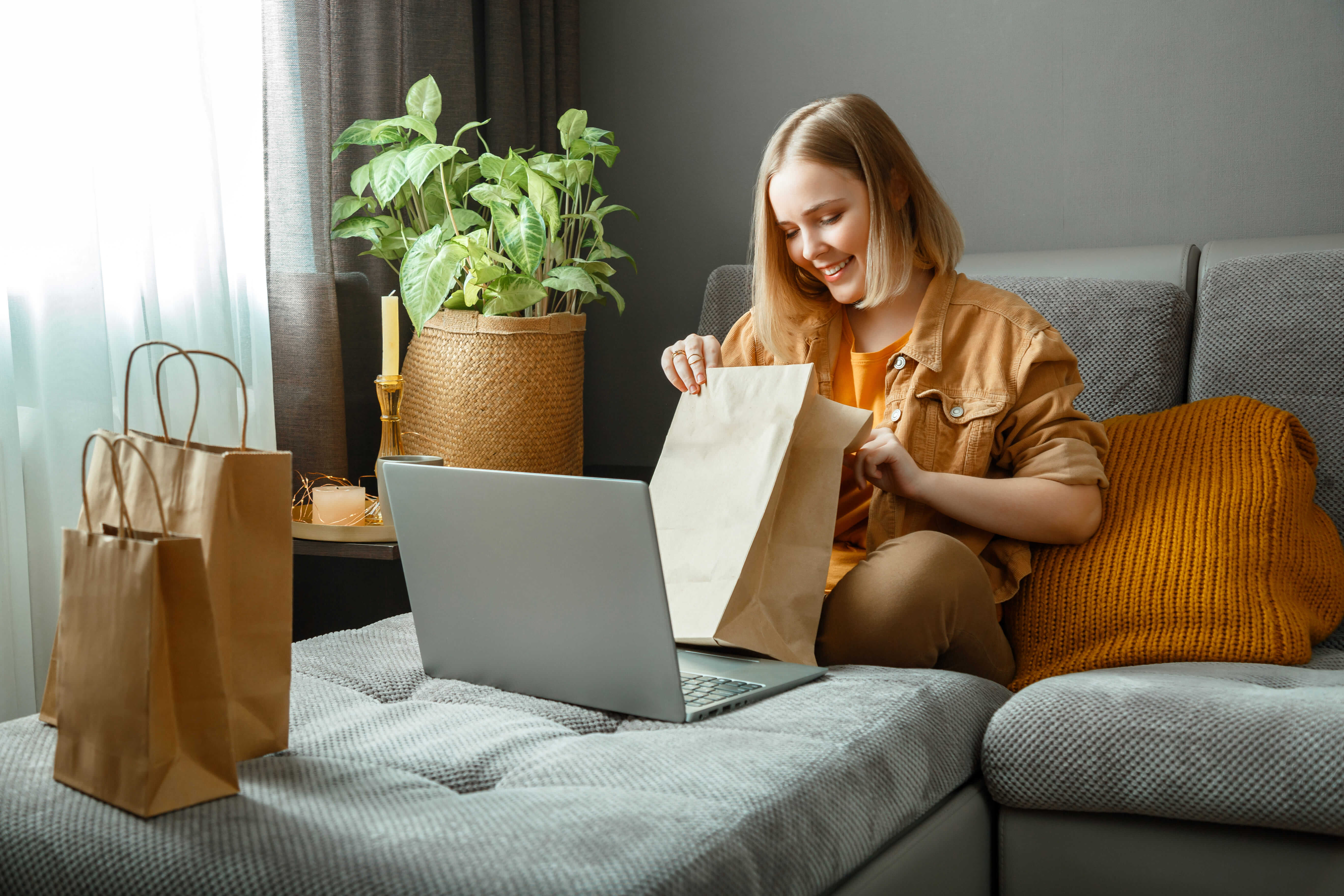 Happy young woman unpacking online orders from Ecommerce Store